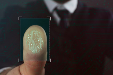 Image of Businessman using biometric fingerprint scanner, closeup. Space for text