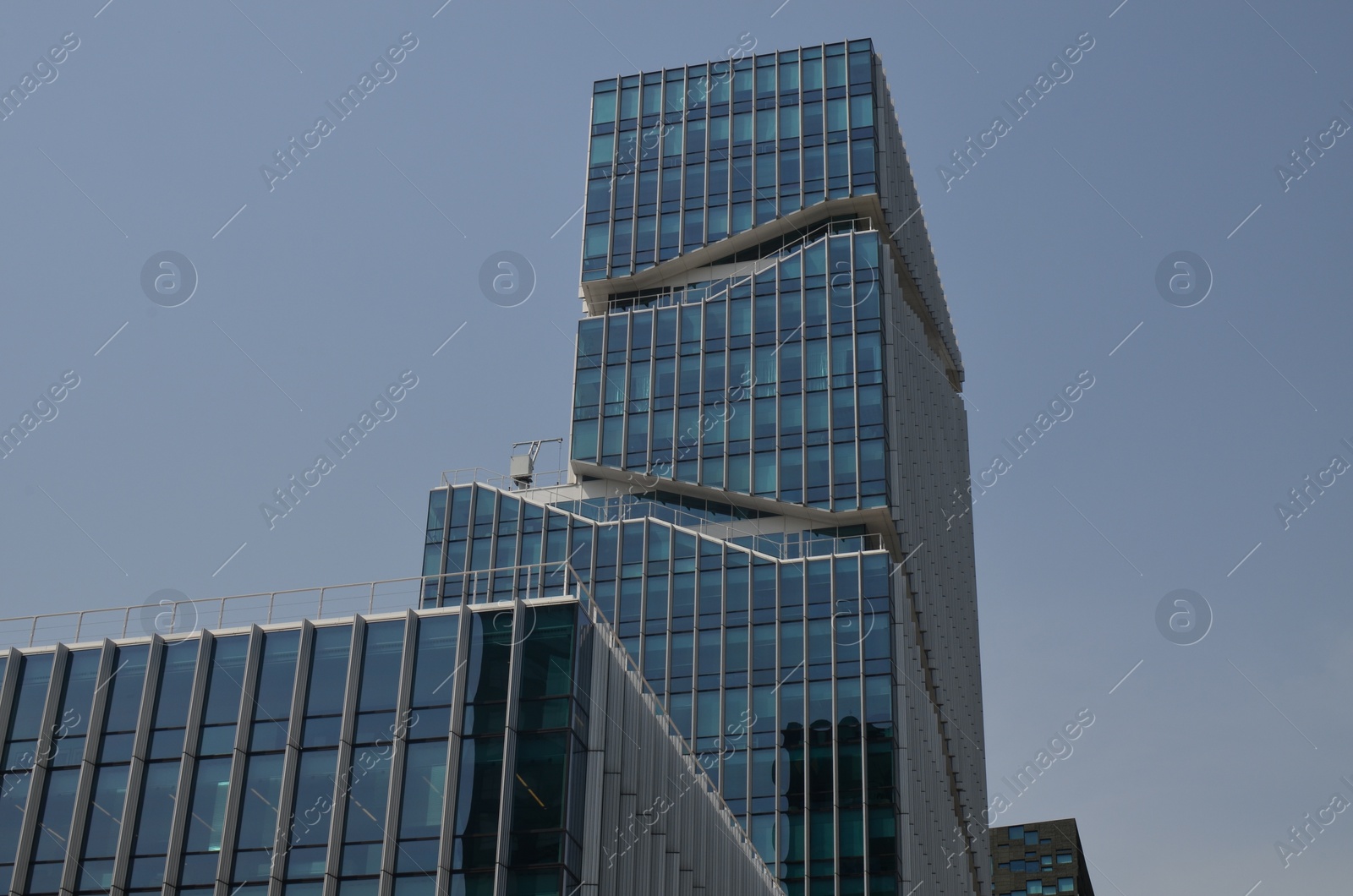 Photo of Exterior of beautiful modern skyscraper against blue sky