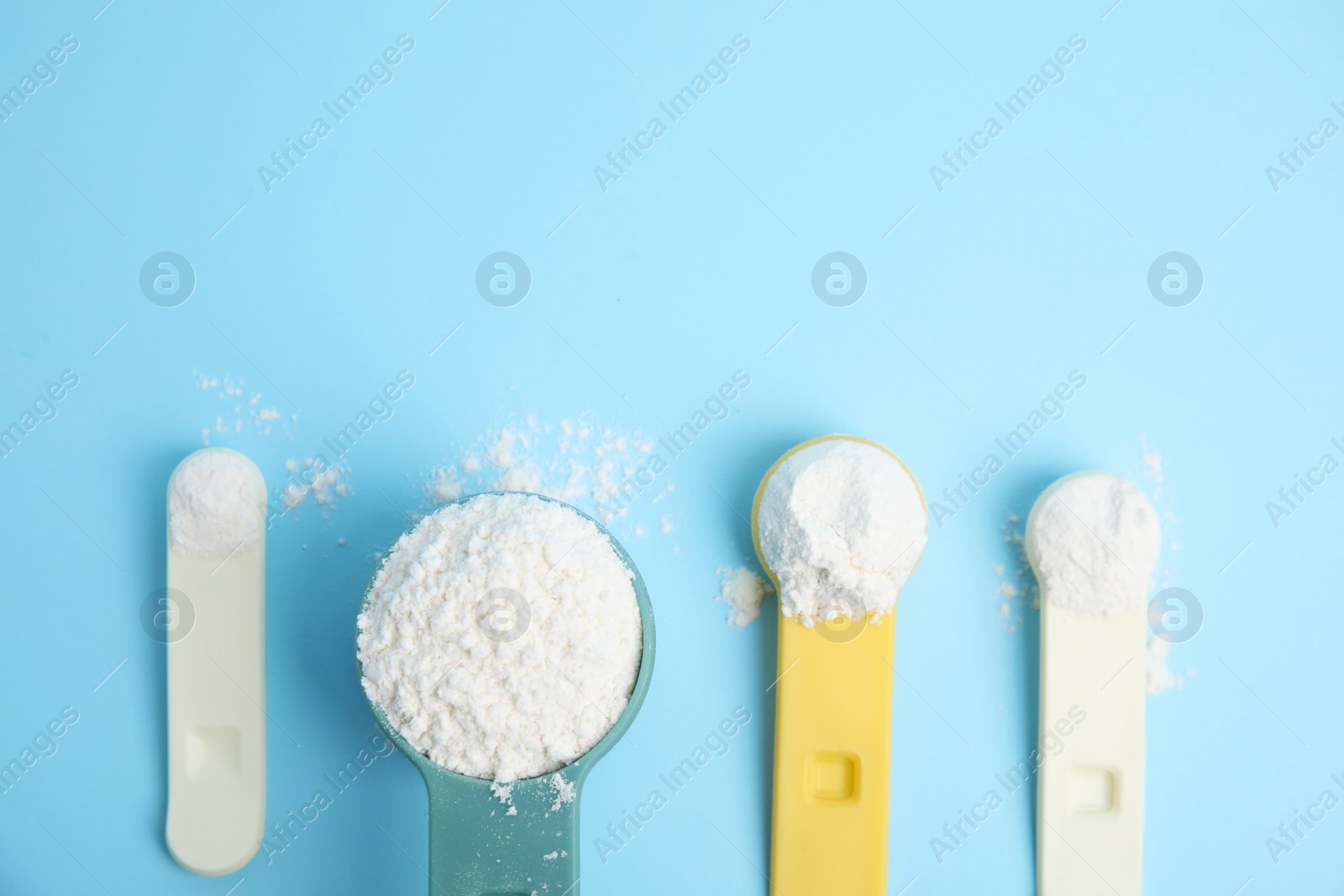 Photo of Amino acid powder on light blue background, flat lay. Space for text