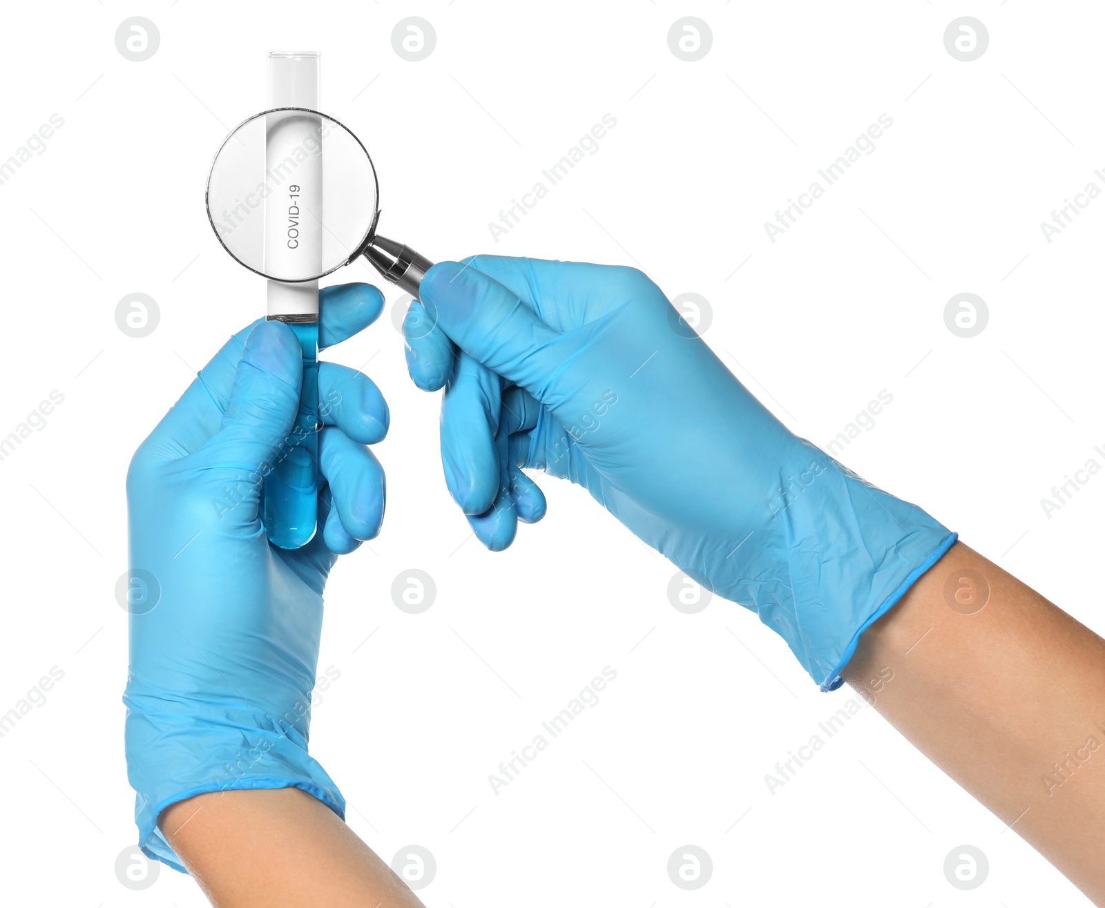 Photo of Scientist with magnifying glass examining test tube with label Covid-19 on white background, closeup