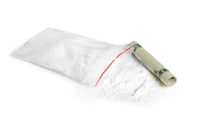 Photo of Cocaine in plastic bag and rolled money bill on white background