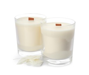 Photo of Aromatic soy candles with wooden wicks on white background