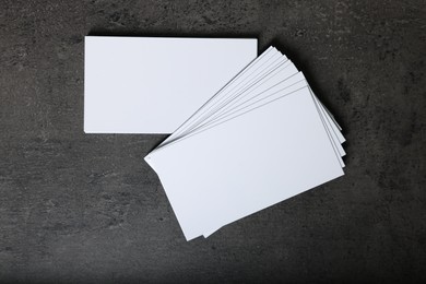 Photo of Blank business cards on grey textured background, top view. Mockup for design