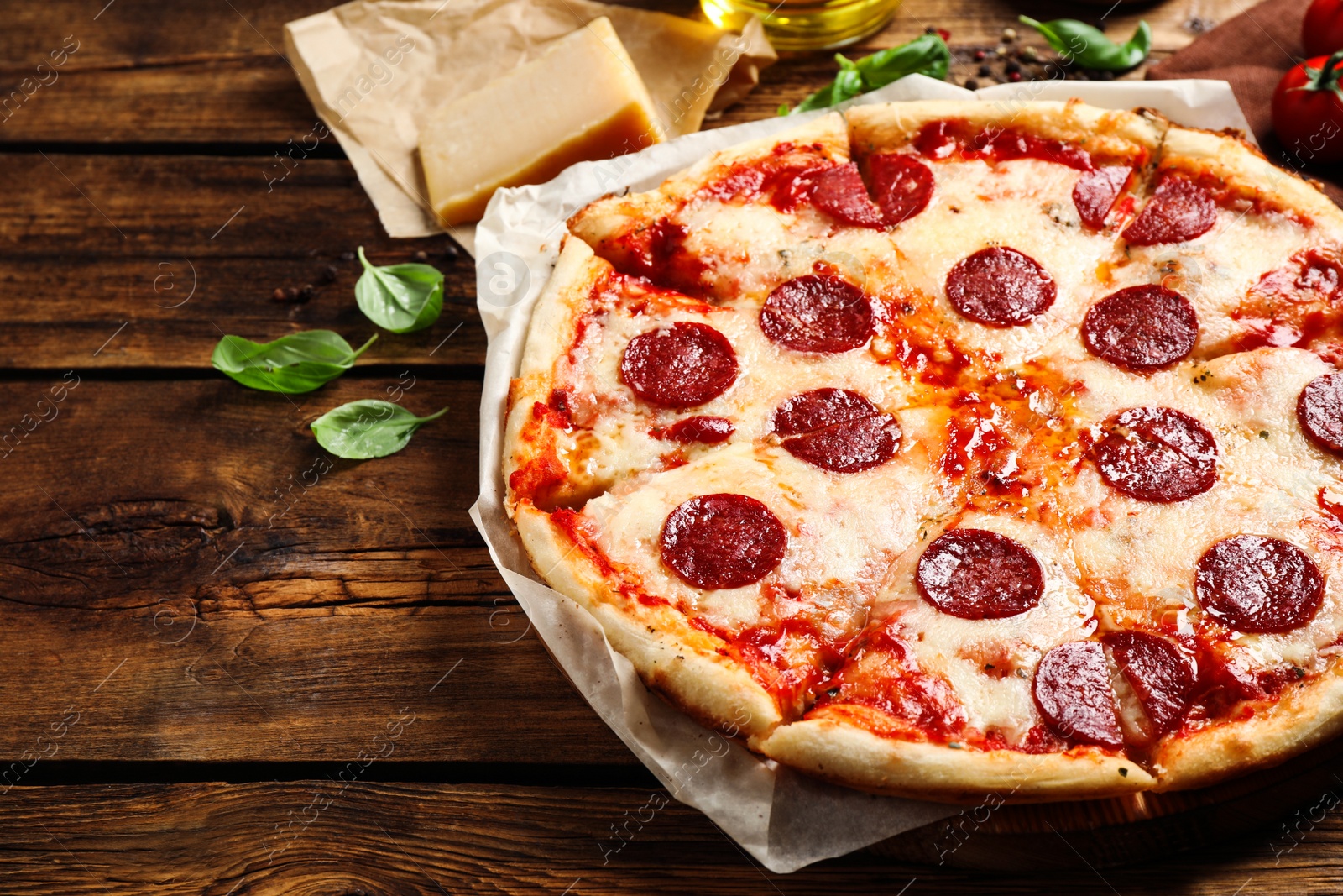 Photo of Hot delicious pepperoni pizza on wooden table