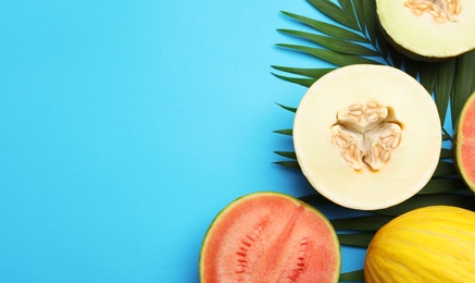 Photo of Flat lay composition with tasty melon and watermelon on blue background, space for text