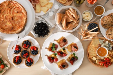 Photo of Dishes with different food on table, flat lay. Luxury brunch