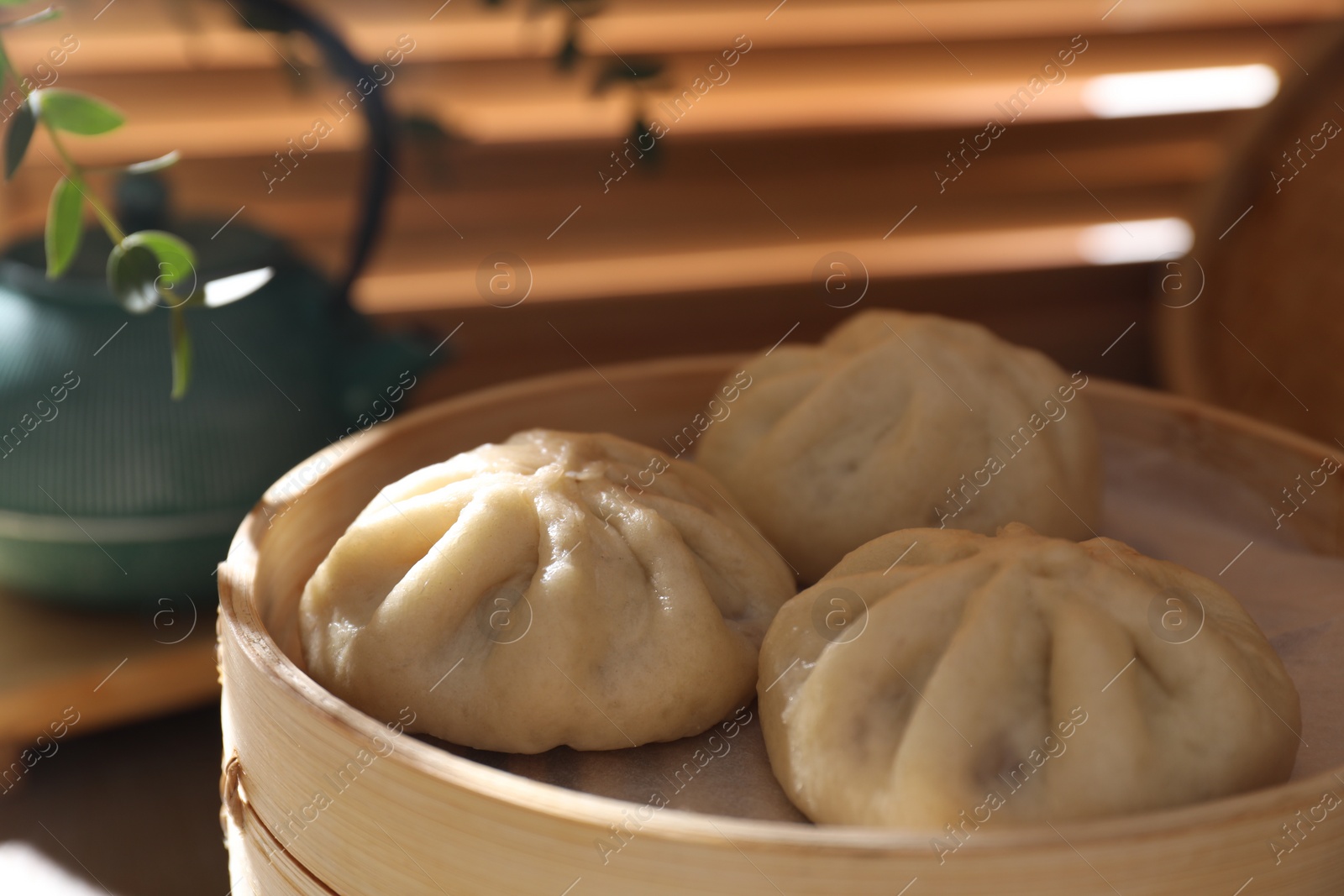 Photo of Delicious bao buns (baozi) on table, closeup