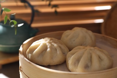 Delicious bao buns (baozi) on table, closeup
