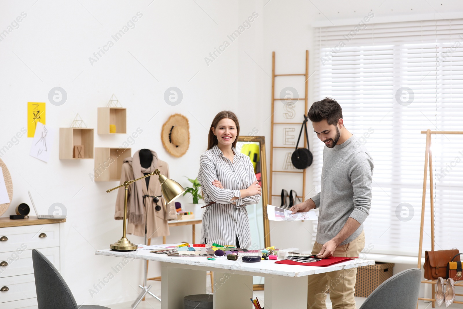 Photo of Fashion designers creating new clothes in studio