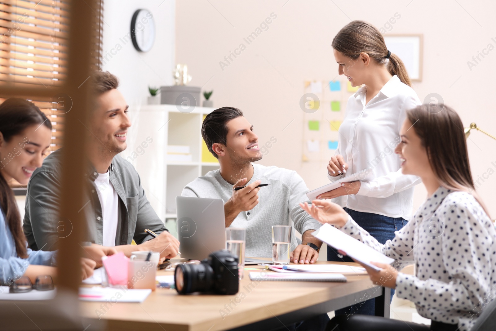 Photo of Team of professional journalists working in office