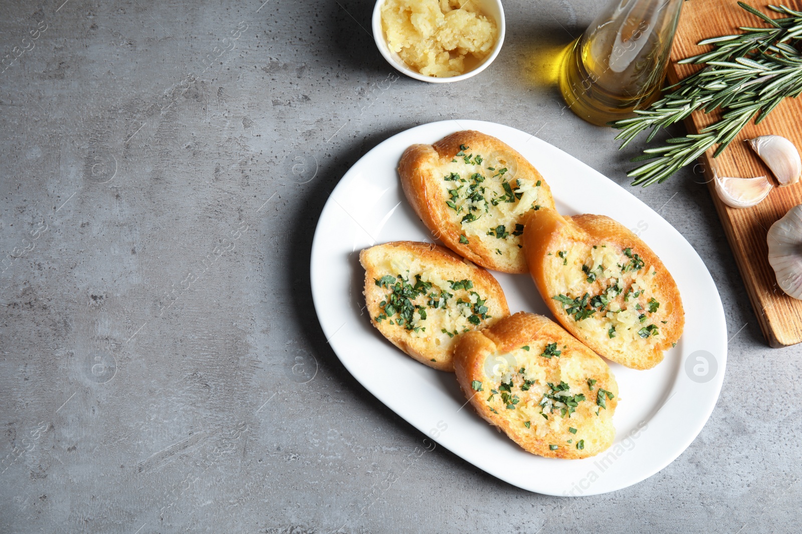 Photo of Flat lay composition with tasty garlic bread and space for text on table