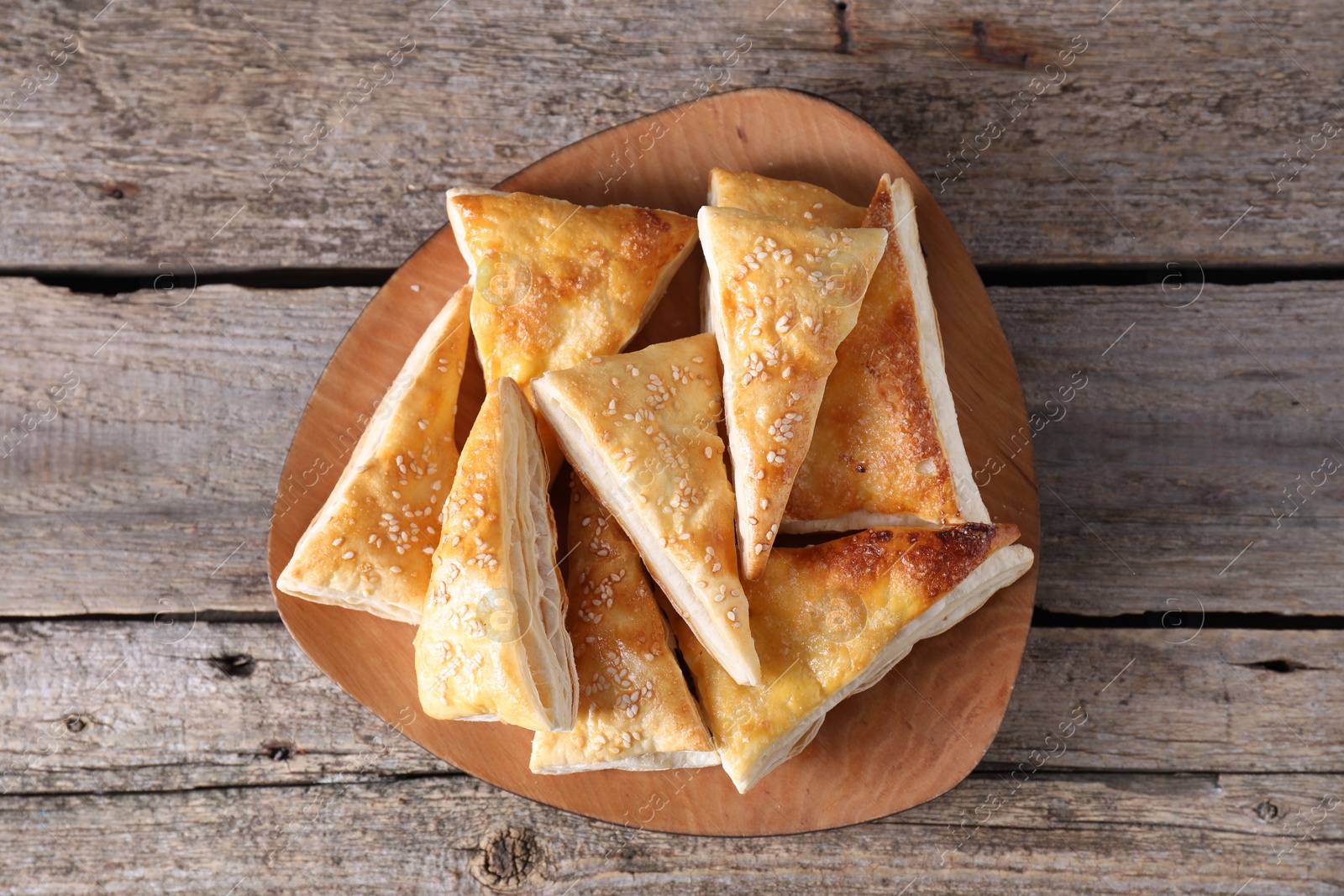 Photo of Delicious puff pastry on wooden table, top view