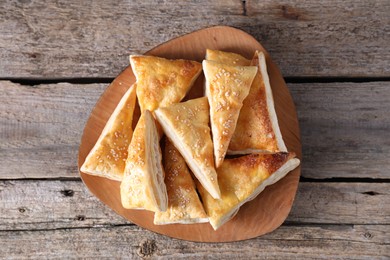 Delicious puff pastry on wooden table, top view