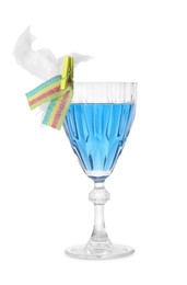 Photo of Bright cocktail in glass decorated with cotton candy and sour rainbow belt isolated on white
