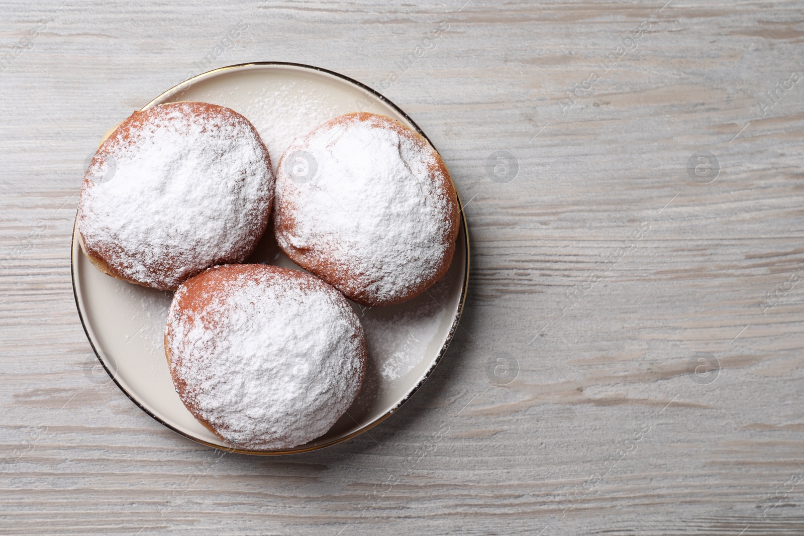 Photo of Delicious sweet buns on wooden table, top view. Space for text