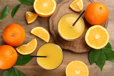 Photo of Delicious orange juice and fresh fruits on wooden table, flat lay