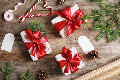 Photo of Flat lay composition with Christmas gifts on wooden background