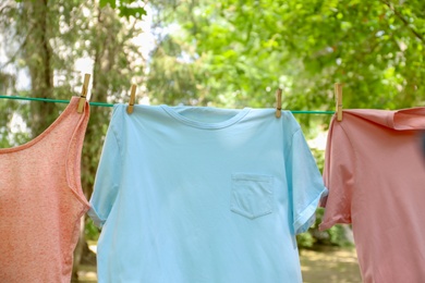 Photo of Laundry line with clothes outdoors on sunny day