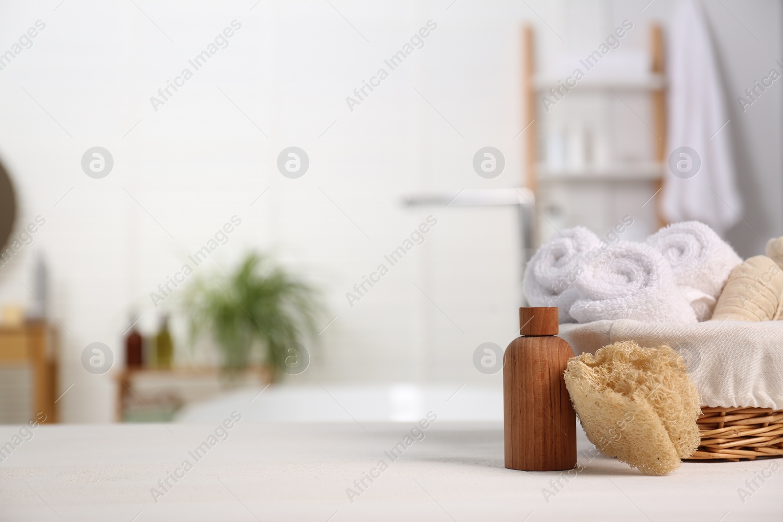 Photo of Composition with spa cosmetic product on white table in bathroom, space for text