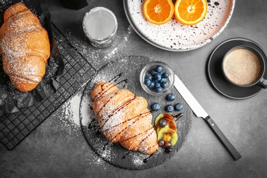 Photo of Tasty croissants served for breakfast on table, top view