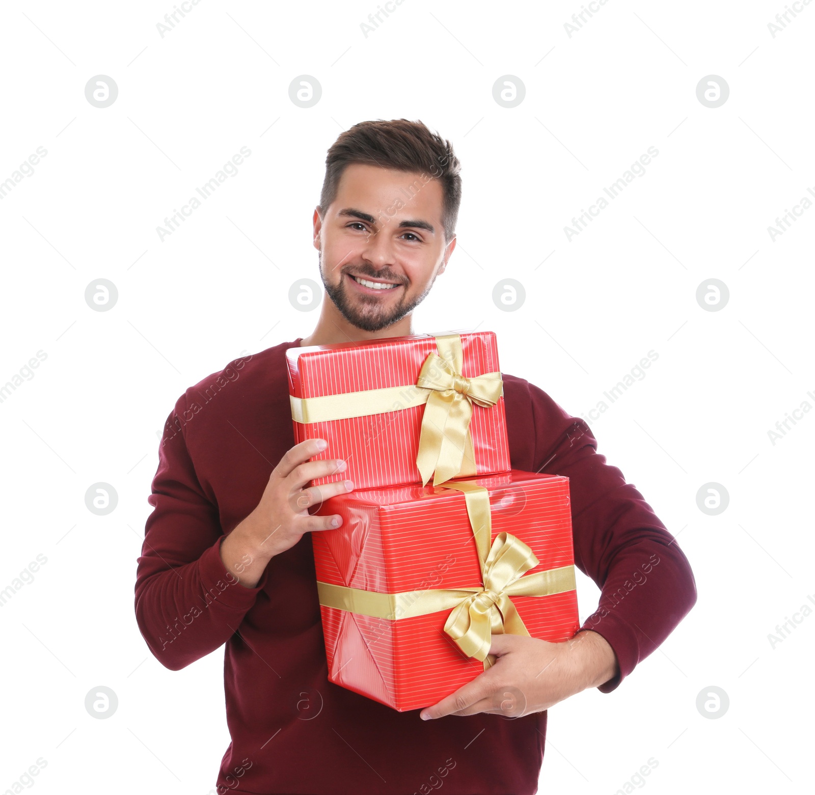 Photo of Happy young man holding Christmas gifts on white background