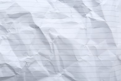 Crumpled lined notebook sheet as background, top view