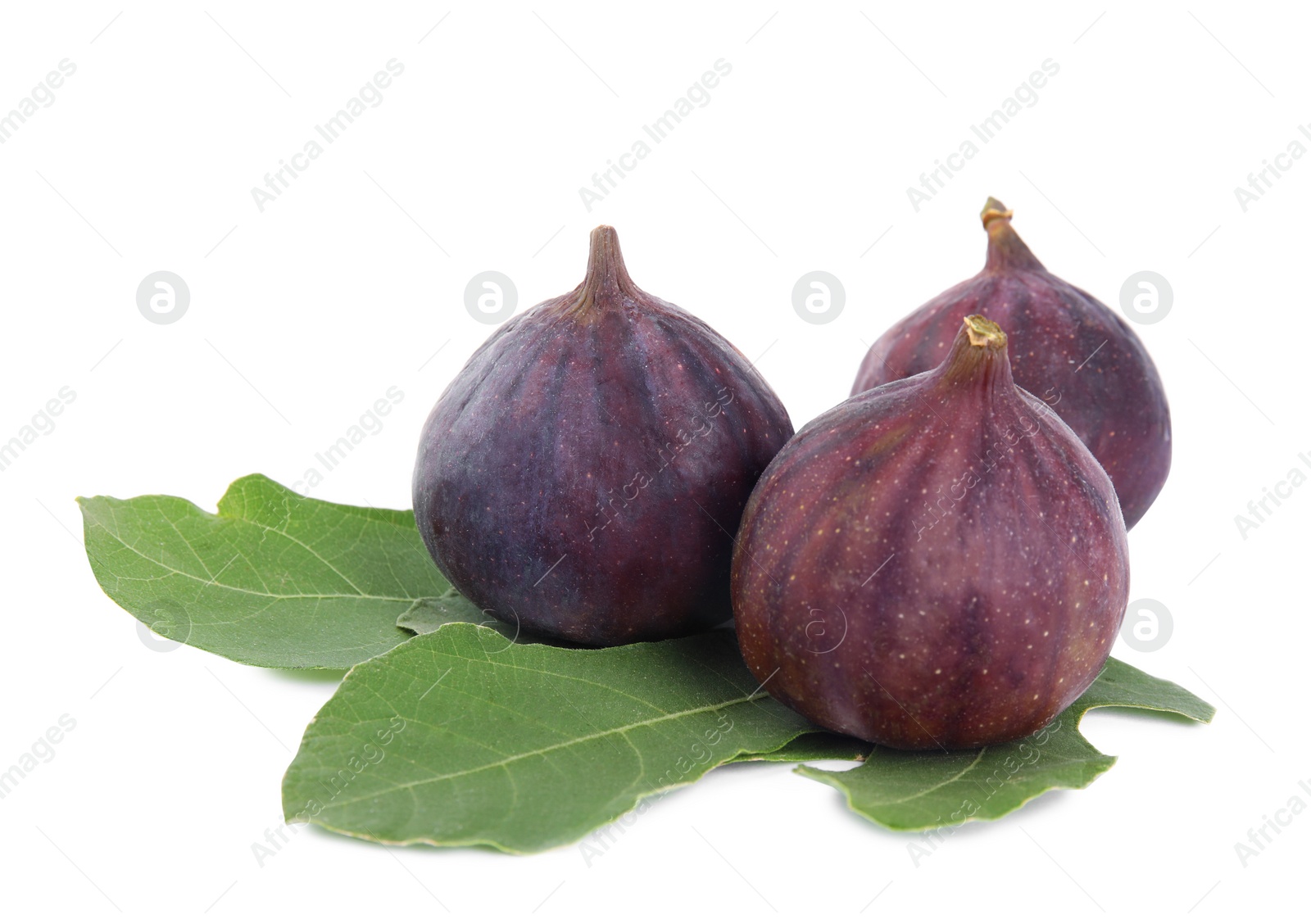 Photo of Fresh juicy purple figs and green leaves on white background