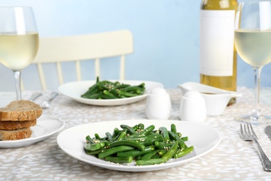 Photo of Tasty green beans with sesame seeds served for dinner on table