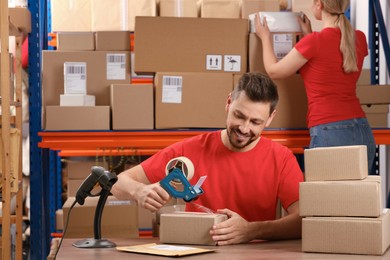 Man and woman working at post office