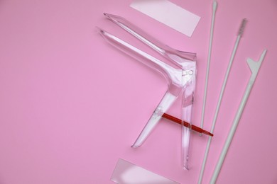 Photo of Sterile gynecological examination kit on pink background, flat lay. Space for text