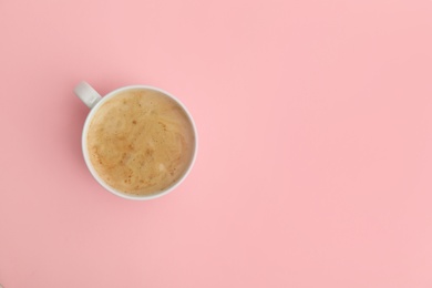 Photo of Cup of coffee on pink background, top view. Space for text