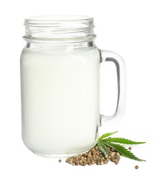 Photo of Mason jar of fresh hemp milk, leaf and seeds on white background
