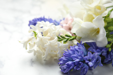 Photo of Beautiful spring flowers on white table, closeup