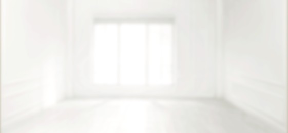 Image of Empty room with white walls and large window, blurred view. Banner design