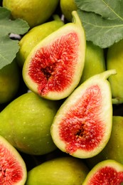 Photo of Cut and whole green figs as background, top view