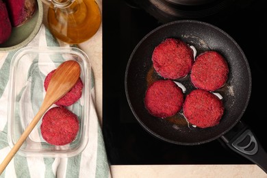 Photo of Frying vegan cutlets on cooktop, flat lay