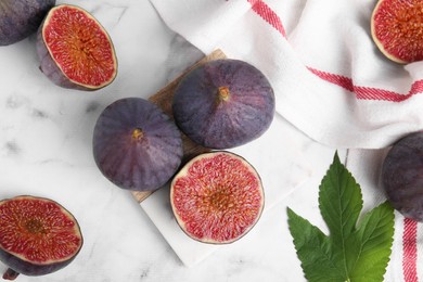 Photo of Fresh ripe purple figs on white marble table, flat lay