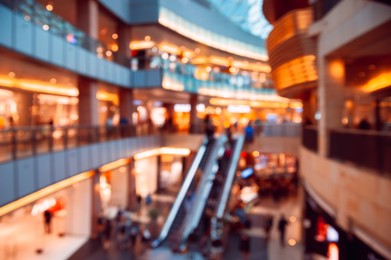 Big shopping mall with many stores, blurred view