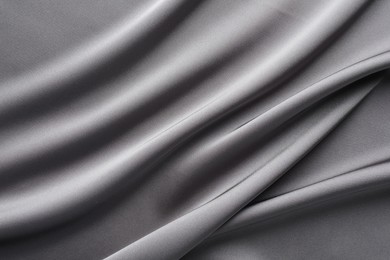 Photo of Texture of beautiful light grey silk fabric as background, closeup