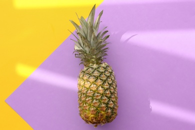Photo of Fresh ripe pineapple on color background, top view