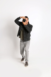 Photo of Professional photographer working on white background in studio