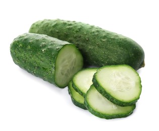 Photo of Whole and cut cucumbers on white background