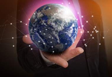 Image of World in our hands. Man holding digital model of Earth, closeup view 