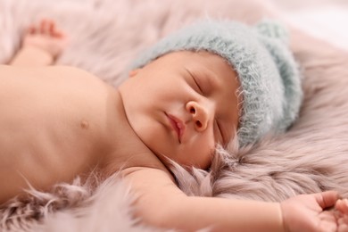Photo of Cute newborn baby sleeping on fluffy blanket, closeup