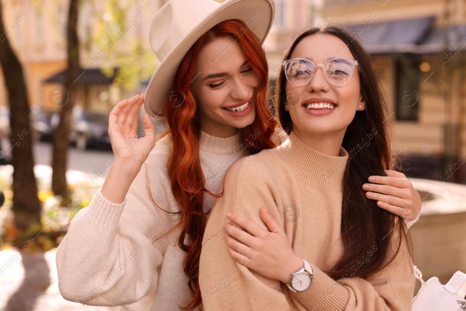 Photo of Happy friends spending time together outdoors on autumn day