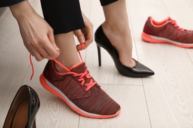 Photo of Woman changing shoes in office, closeup view