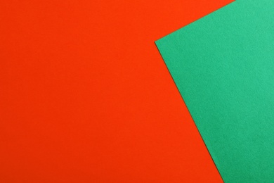 Photo of Green and red paper sheets as colorful background, top view