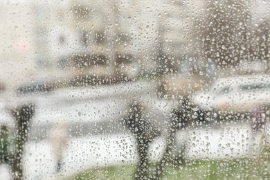 Photo of Closeup view of foggy window with rain drops