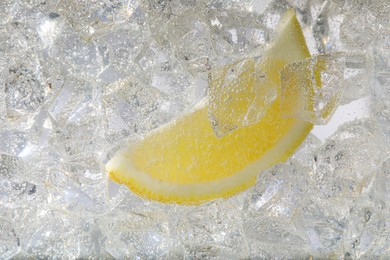 Photo of Juicy lemon slice and ice cubes in soda water on white background, closeup