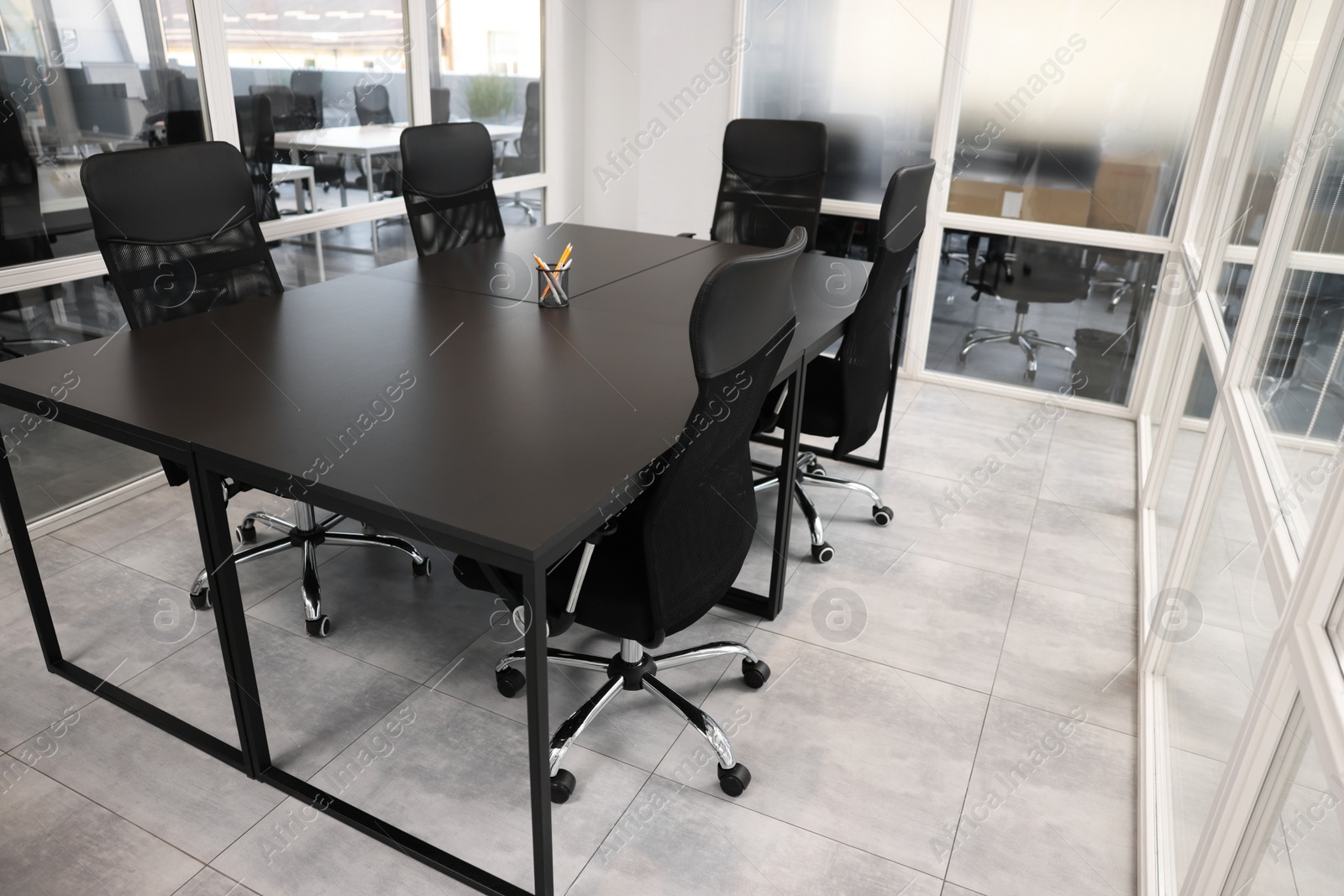 Photo of Comfortable office chairs and tables in meeting room